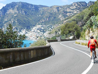 Picture of a cyclist riding towards Positano.